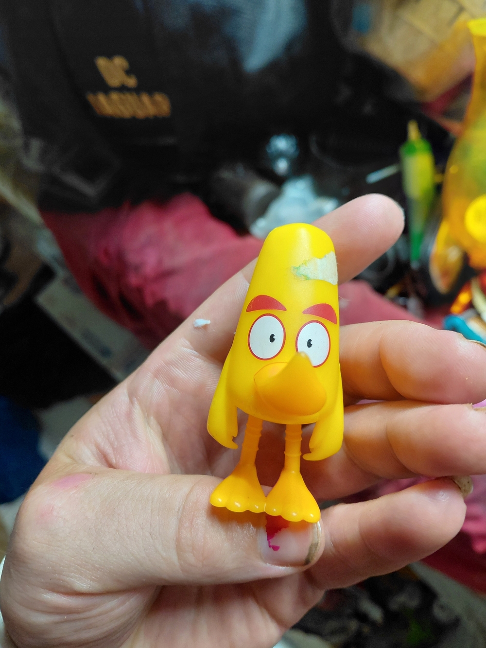 plastic toy of Chuck, the fast yellow bird character from the Angry Birds